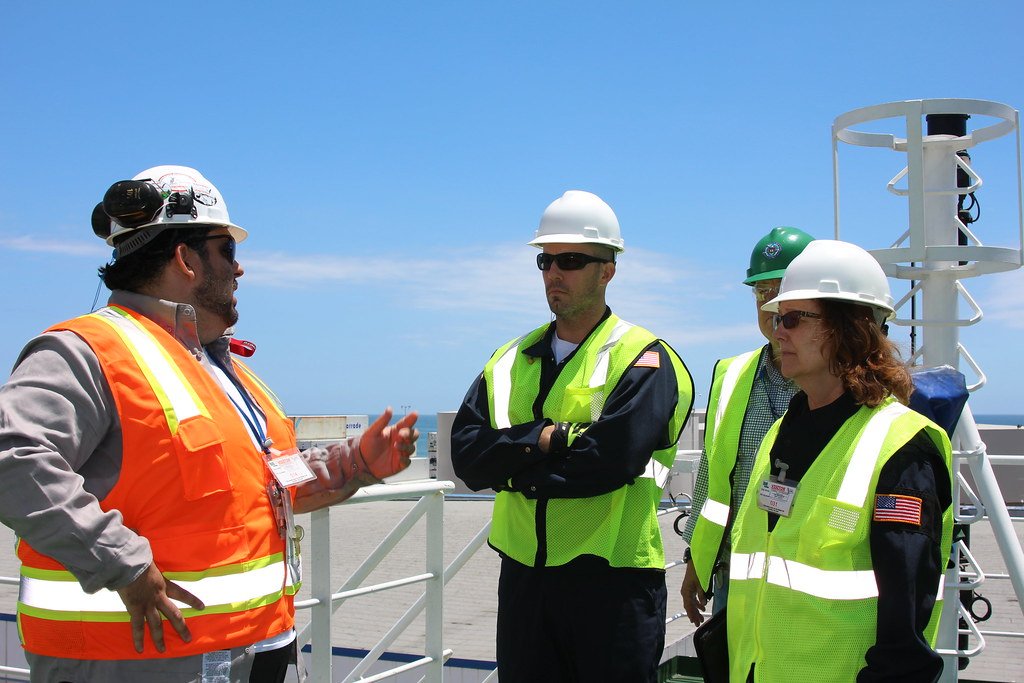 An environmental compliance officer reviews documentation at a facility.